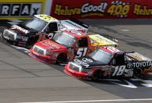 On lap 93, No. 51 Aric Almirola, No. 30 Todd Bodine and No. 18 Kyle Busch got three-wide across the start-finish line in the NASCAR Camping World Truck Series VFW 200 Saturday at Michigan International Speedway in Brooklyn, Mich. Credit: Jerry Markland/Getty Images for NASCAR